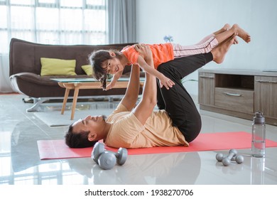 Father Use His Child As Weight For Lifting Exercise At Home