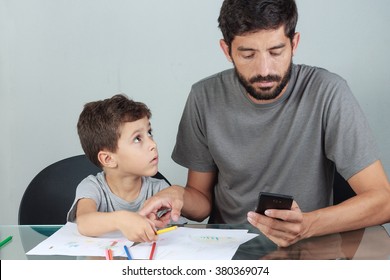 Father using smartphone ignoring his son