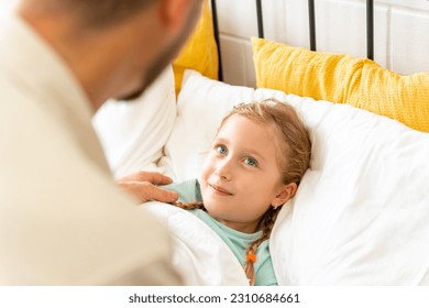 Father wake up a sleeping child daughter on the bed in bedroom in sunny morning. Happy family start a new day together with freshness. Little girl waking up with smiling. - Powered by Shutterstock