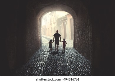 Father walking with his two daughters