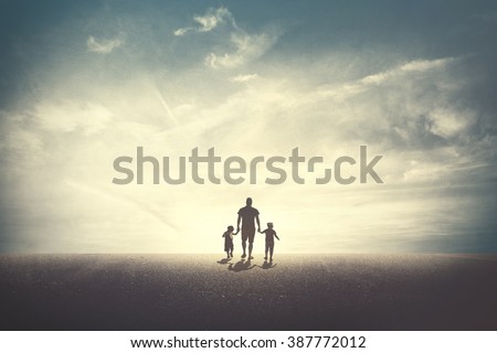 Father walking with his two daughters