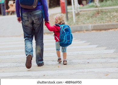 father walking little daughter to school or daycare - Shutterstock ID 488966950