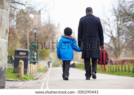 Father Walking Son To School Along Path