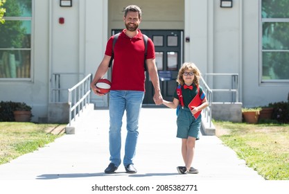 Father walking son to school. Parent and pupil of primary school schoolboy with backpack. - Powered by Shutterstock