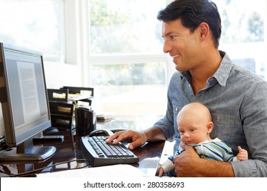 Father working in home office with baby