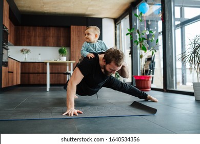 Father working out, doing single arm plank with his jolly infant baby riding on his neck. At home apartment. - Shutterstock ID 1640534356