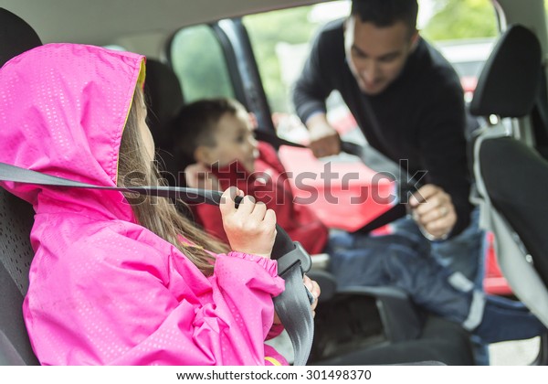 A\
Father worried about her children\'s safety in a\
car