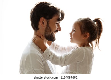  fatherhood.Parenthood. Family. Love. Dad is holding his little daughter in his arms. Both are looking at each other and smiling. On white background