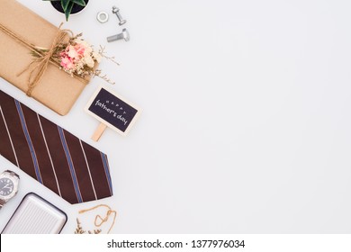 Father's day background concept. Beautiful small handmade DIY gift box (package), father's necktie, gentleman accessories and small blackboard with Happu Father's day text on white background. - Powered by Shutterstock