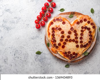 Father's day background with pizza in heart shape and dad word. Pepperoni pizza in heart shape with dad lettering on gray cement background. Copy space for text. Father day concept, recipe and idea - Powered by Shutterstock