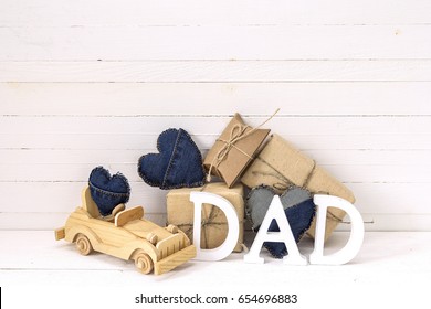 Fathers Day Background With Wooden Toy Car, Gift Boxes And  Letters Dad. Happy Fathers Day Concept. Place For Text. 
