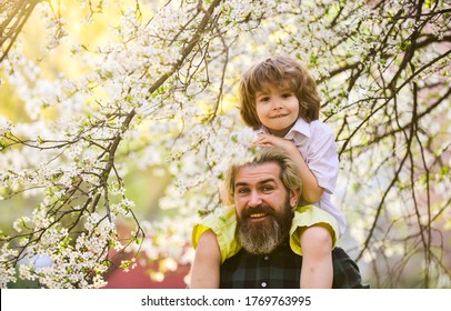 Fathers Day. Child Having Fun With Dad. Happy Family. Little Boy And Father In Nature Background. Springtime. Hipster Piggybacking Baby. Bearded Brutal Man Good Father. Dad And Son. Best Dad Ever.