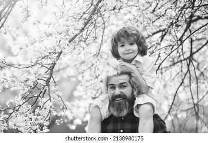 Fathers Day. Child Having Fun With Dad. Happy Family. Little Boy And Father In Nature Background. Springtime. Hipster Piggybacking Baby. Bearded Brutal Man Good Father. Dad And Son. Best Dad Ever