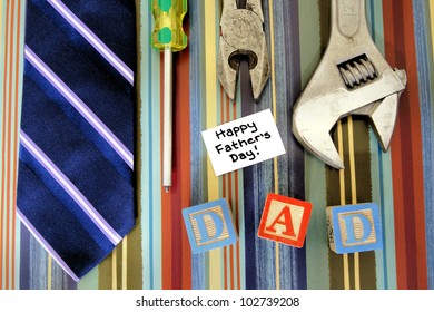 Father's Day collection of tools, tie and gift tag on patterned paper background - Powered by Shutterstock