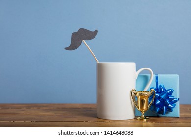 Father's Day Composition With Gifts, Coffee Mug And Paper Mustache