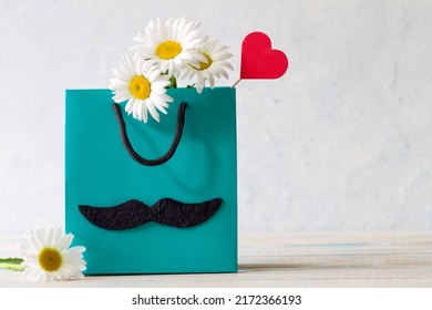 Fathers Day Concept With Flower And Heart In Gift Bag On Light Background 