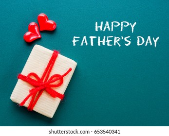 Father's day concept.  HAPPY FATHER'S DAY text with colorful heart and gift on green background - Powered by Shutterstock