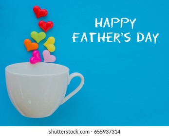 Father's day concept.  HAPPY FATHER'S DAY text with colorful heart in white cup and gift on blue background - Powered by Shutterstock