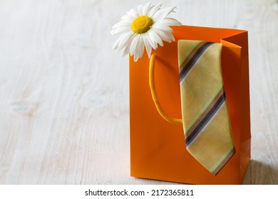 Fathers Day Concept With Necktie And Flower In Gift Bag On Light Background 