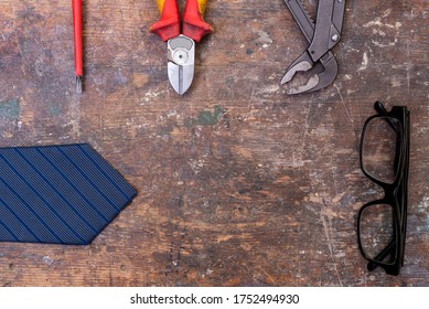 Fathers Day Concept Tools, Tie And Glasses Arranged On A Wooden Work Bench Flat Lay Shot From Above With Copy Space
