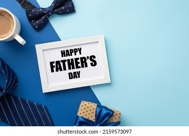 Father's Day concept. Top view photo of white photo frame polka dot giftbox with blue ribbon bow cup of coffee bow-tie and necktie on bicolor blue background with copyspace - Powered by Shutterstock