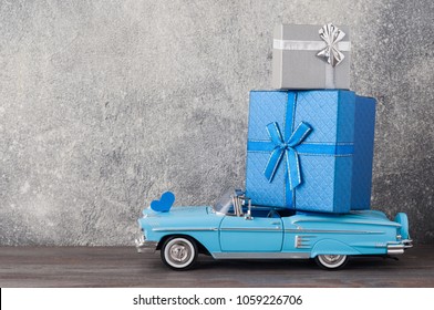 Father's Day Concept. A Toy Car With Gifts, Heart, 19th Of July On Wooden Background. Copy Space For Fathers Day Greeting Card.