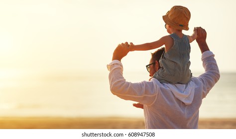 Father's Day. Dad And Baby Son Playing Together Outdoors On A Summer Beach
