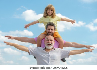 Fathers day. Family man different ages on weekend. Father and son with grandfather raising hands or open arms flying. Men generation.