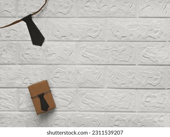 Father's Day Gifts. Copy space. DIY gift wrapping. Gift box with tie on white brick wall background. Flat design. Gift wrapping idea for Father's Day, Grandfather's Day, birthday, bachelor party.  - Powered by Shutterstock