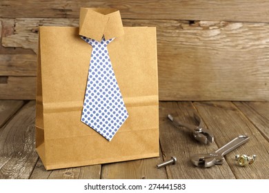 Fathers Day Handmade Shirt And Tie Gift Bag With Tools On A Wood Background