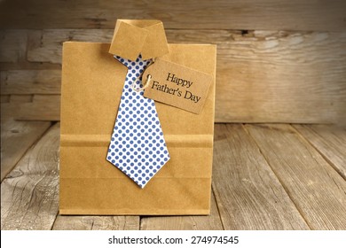 Fathers Day Handmade Shirt And Tie Gift Bag With Greeting Card On A Wood Background