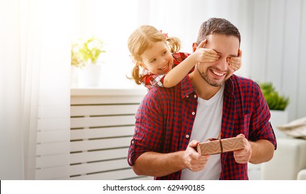 Father's day. Happy family daughter hugging dad and laughs on holiday - Shutterstock ID 629490185