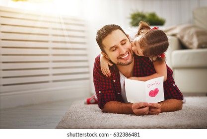Father's day. Happy family daughter kiss dad and giving greeting card  on holiday - Shutterstock ID 632386481