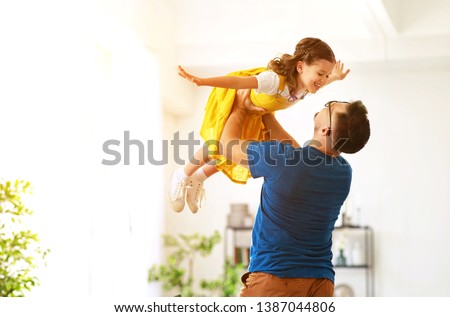 Father's day. Happy family daughter hugs his dad  on holiday