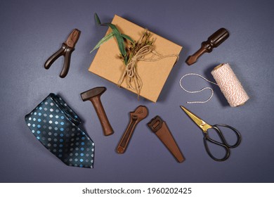 Father's Day Or Masculine Birthday Theme Flatlay Background Styled With Gift, Chocolate Tool Set And Tie. Blog Hero Header Creative Composition.