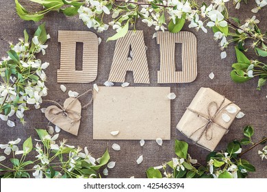 Fathers Day Message From Cardboard Letters, Blank Card And A Gift Box With Apple Blossoms. Happy Fathers Day Concept.