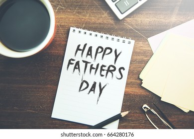 Fathers day text on page with stationary on table