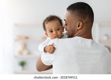 Father's Love. Young Afrian American Dad Holding His Sweet Infant Baby In Hands, Closeup Shot Of Caring Black Millenial Dad Spending Time With Cute Adorable Toddler Child At Home, Copy Space