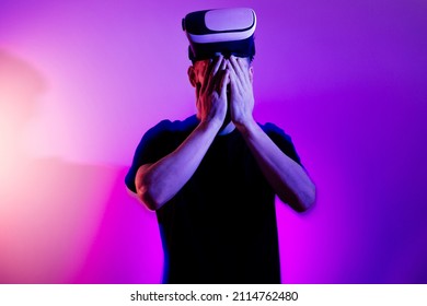 Fatigue From Digital Technology.  Man Using VR Virtual Reality Glasses. Futuristic Metaverse Universe Games And Future In Digital. Entreatment And NFT In Neon Colorful Video In 3d Cyber Space. 