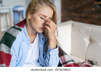 Fatigue and upset woman touching nose bridge feeling eye strain or headache, trying to relieve pain. Sick and exhausted female spending day at home. Depressed lady feeling weary dizzy - Shutterstock ID 2073678815