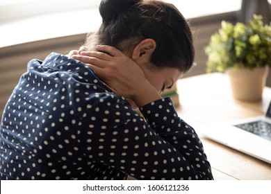 Fatigued Indian Woman Student Office Worker Massage Sore Neck Stiff Muscles Tired From Computer Work At Desk On Bad Chair In Incorrect Position Feel Back Pain Ache Concept, Closeup Over Shoulder View