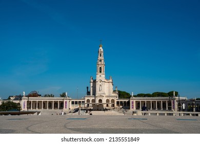 Fatima, Portugal - November 13 2022 - People Passing The Square In Front Of The Basilica Of Our Lady Of The Rosary Of Fatima