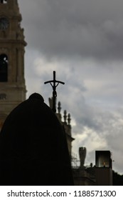 Fatima Shrine, Pope Statue From The Back, Sanctuary Tower In The Background. Cloudy Rainy Day.