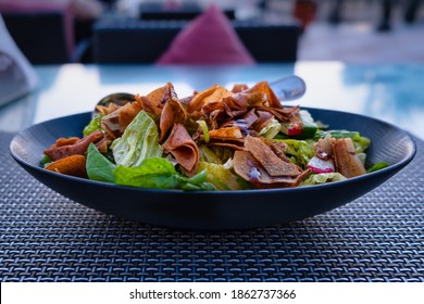 Fattoush (Lebanese Salad) Close Up  Image In A Blue Plate . It Is Made With Vegetables And Crispy Toasted Flatbread, Which Soaks Up The Dressing Beautifully. 