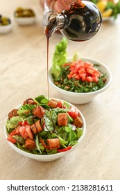 Fattoush and tabouleh iftar ramadan Lebanese salad salad, tabbouleh and fattouch, with pomegranate molasses
sauce pouring