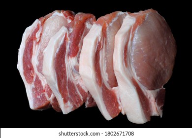 Fatty Large Pieces Raw Pork Of Meat Steak Closeup On A Black Background, Isolate. Ingredient Of The Keto Diet.