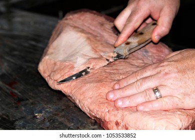 The Fatty Side Of A Beef Brisket Beginning To Be Trimmed Of Its Fat.