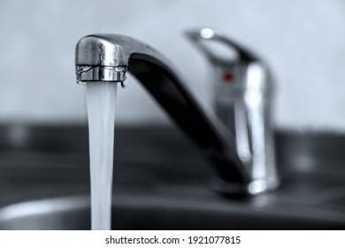 Faucet With Flowing Water In Sink