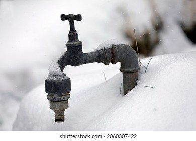 Faucet With Frozen Water, Garden In Winter With Snow And Ice.