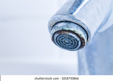 Faucet with limescale. Detail of dirty and calcified bathroom taps before descaling.